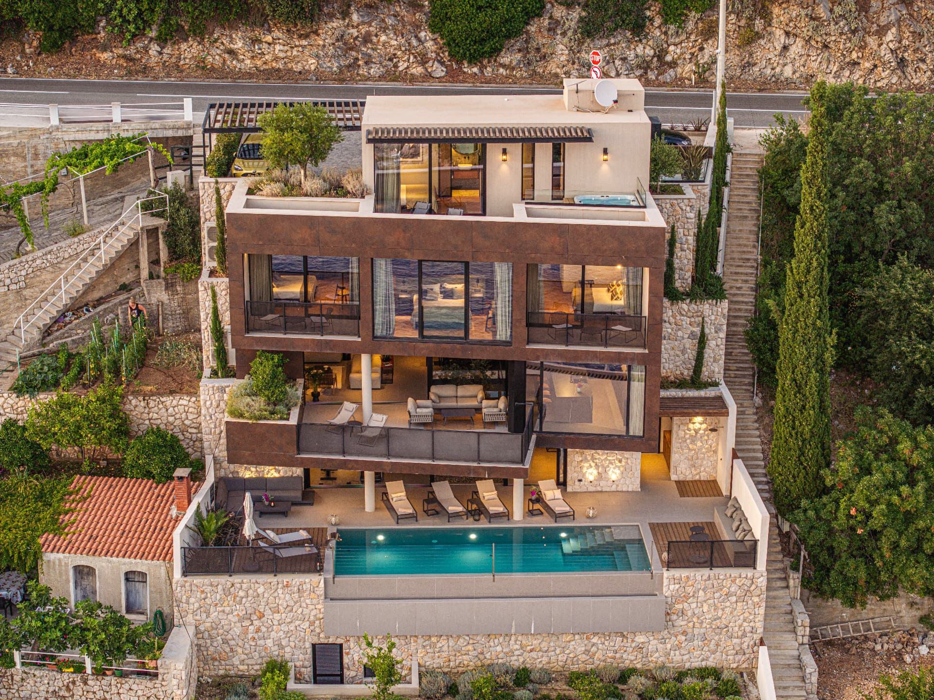 Contemporary Cliffside Villa Illuminated at Dusk above the Infinity Pool