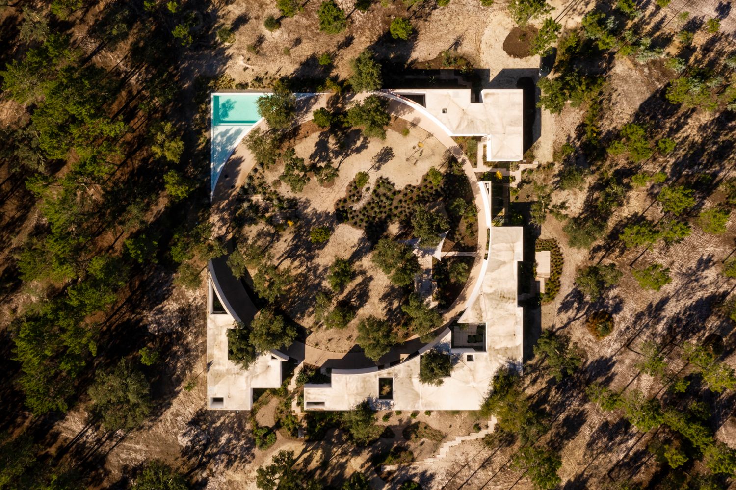 Aerial View of the Villa with Curved Architecture, Pool and Pine Forest