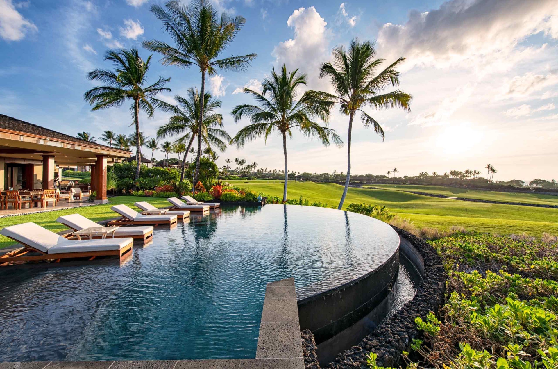 Infinity Pool with Palms and Golf Course Sunset Views