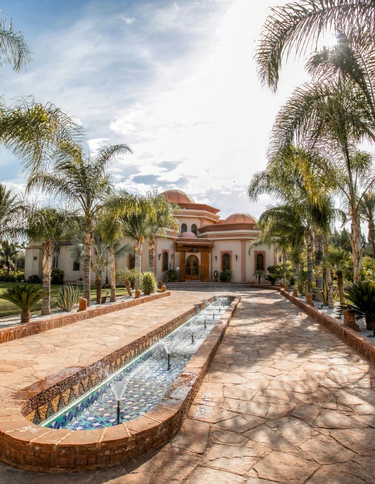 Palm Lined Entrance with Mosaic Fountain and Domed Facade