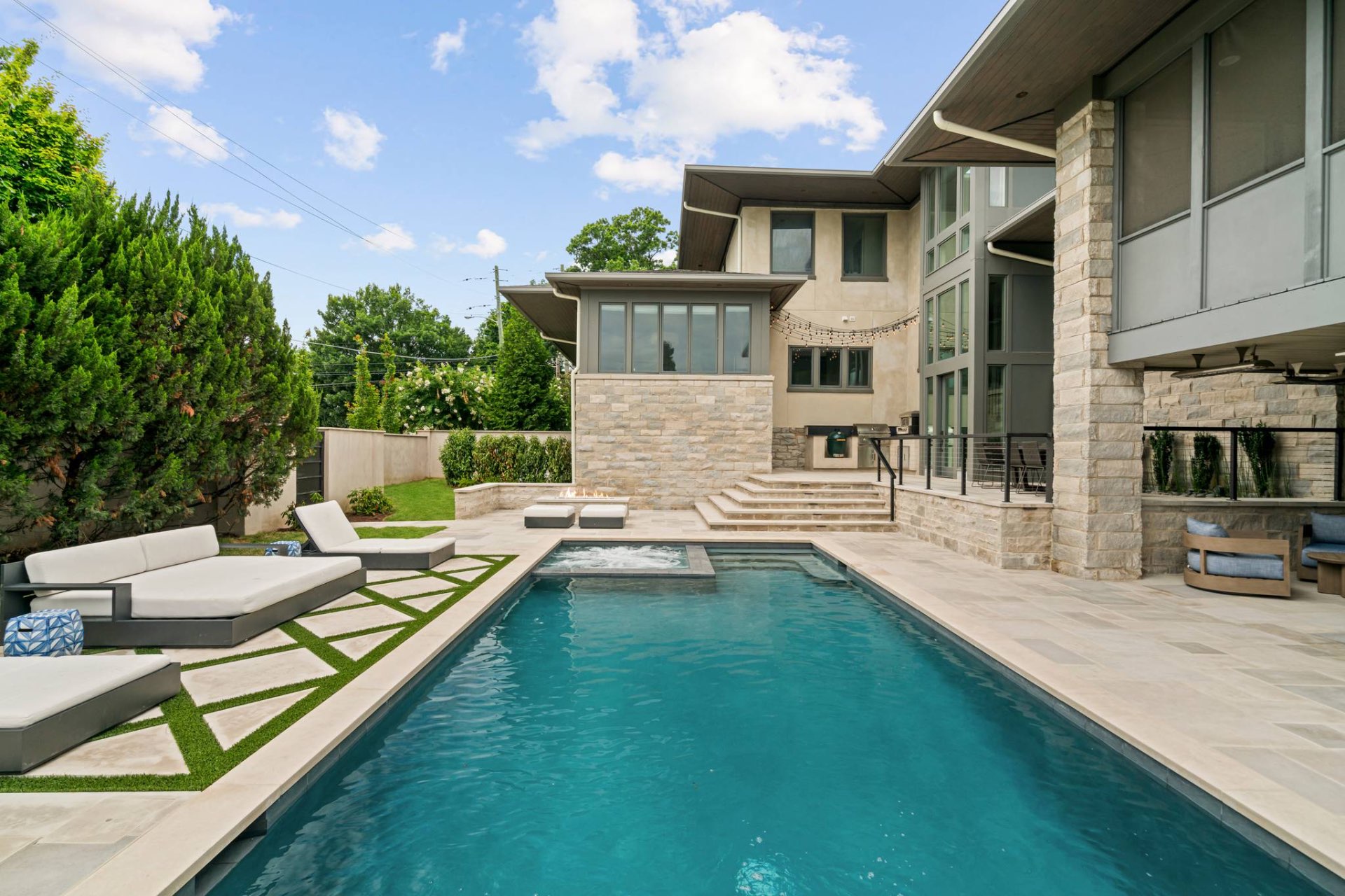Backyard Pool with Sun Loungers and Modern Stone Estate
