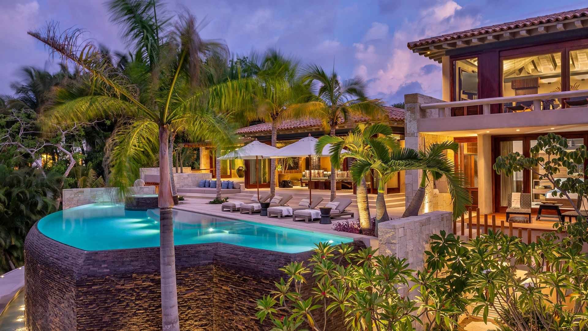 Infinity Pool and Villa at Twilight with Palm Trees