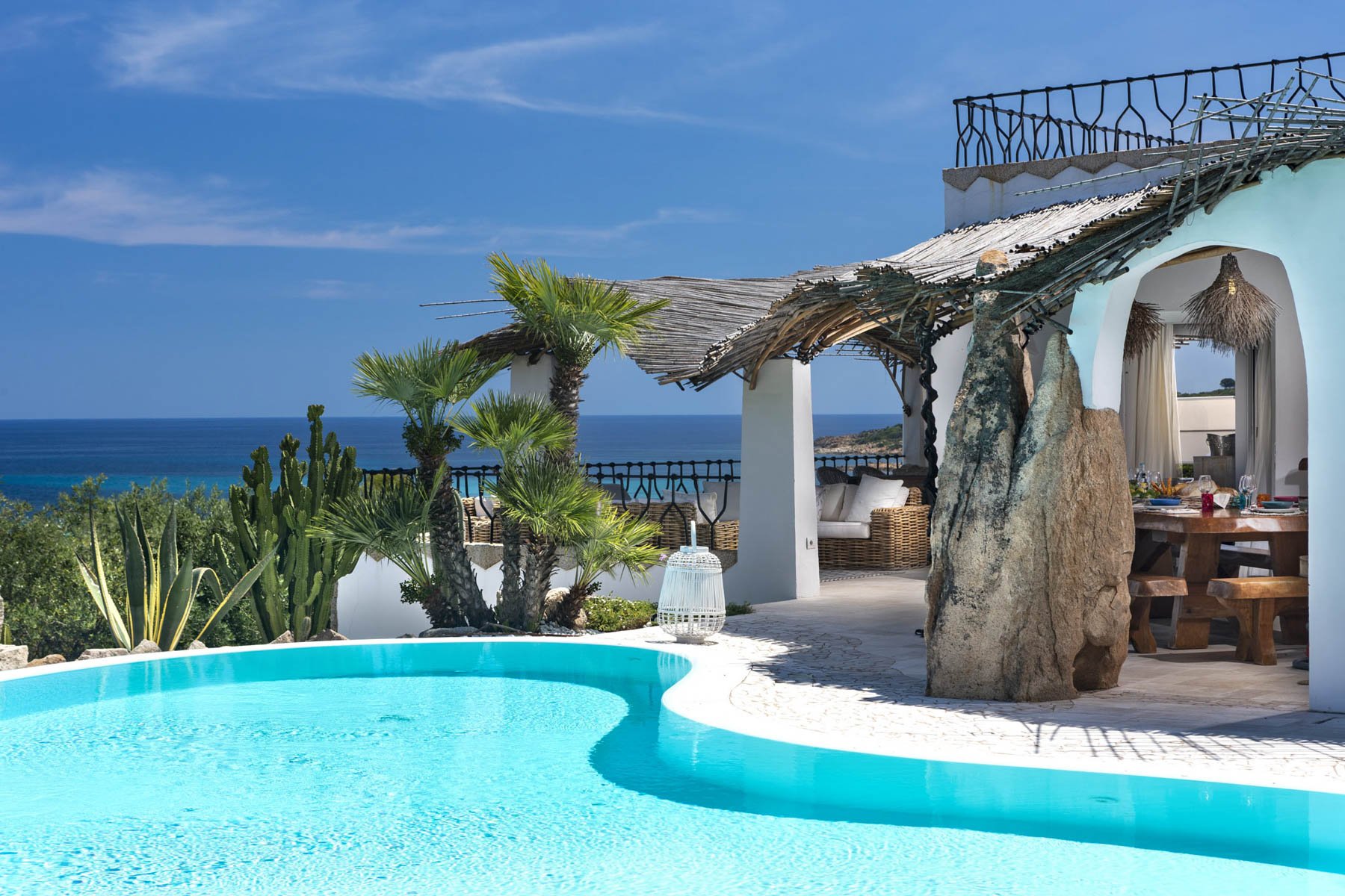 Infinity Pool with Dramatic Natural Rock Features and Mediterranean Sea Views