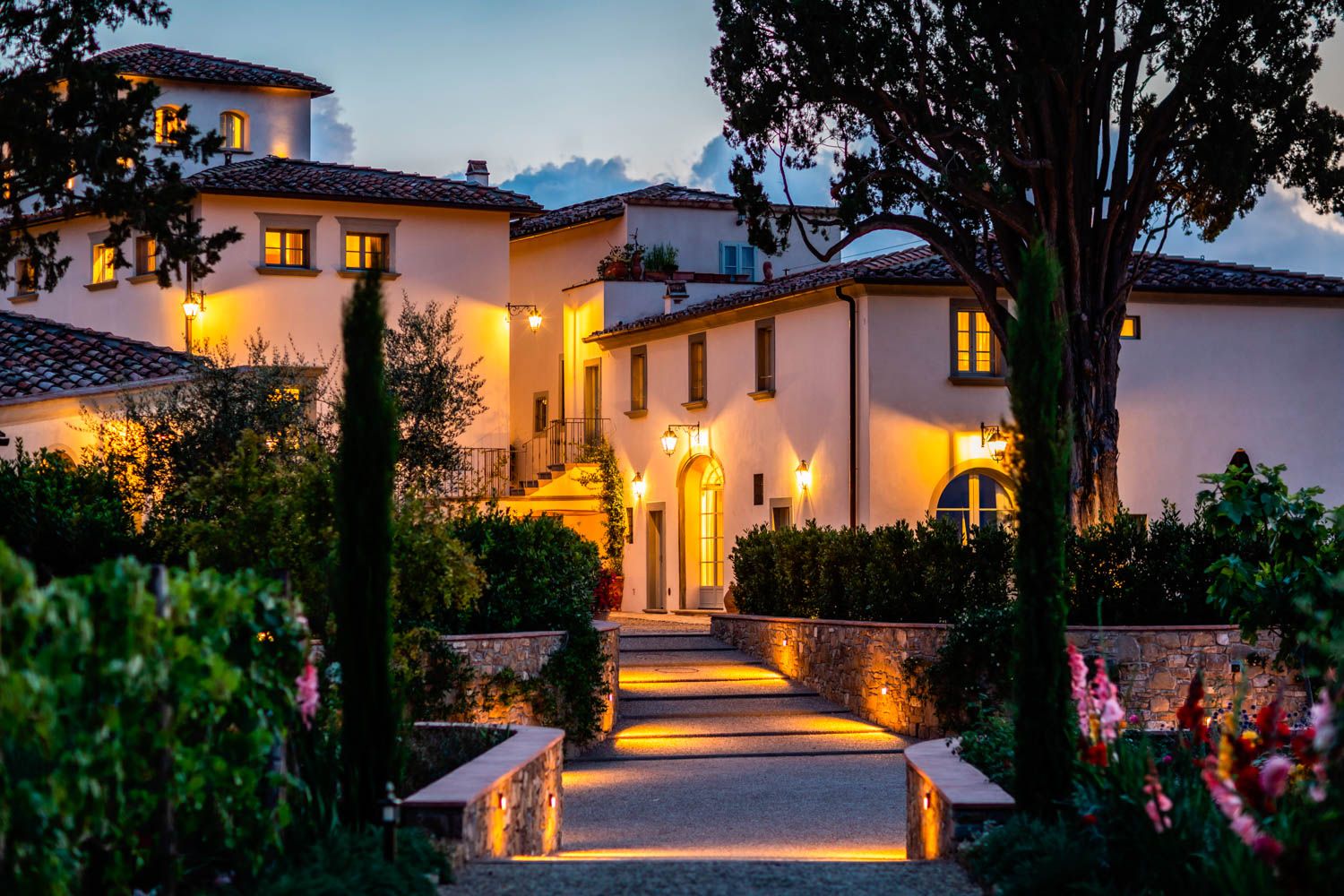 Evening Exterior View of Renaissance Villa with Illuminated Stone Walkway