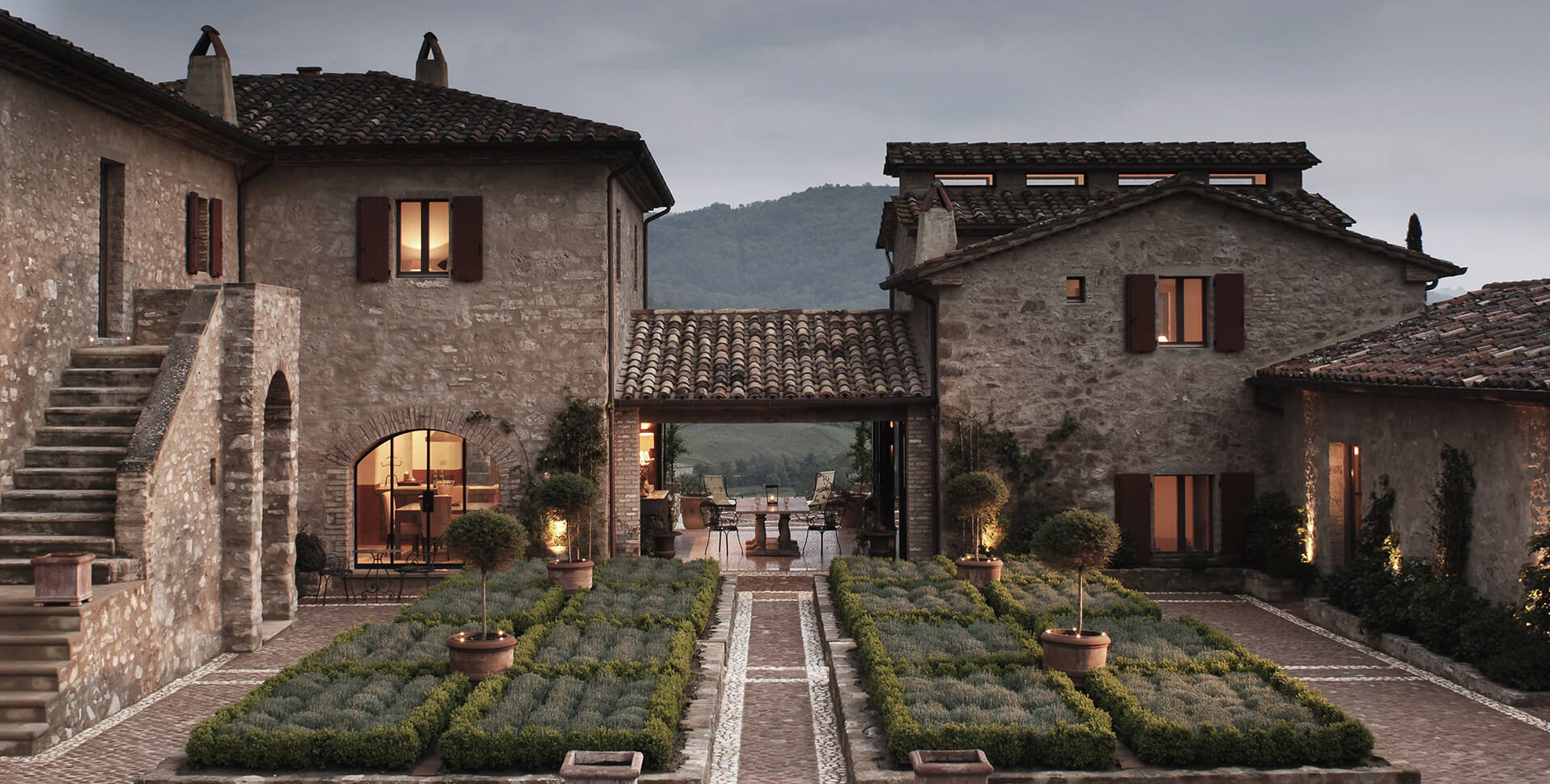 Fortress Estate Courtyard with Formal Gardens at Dusk