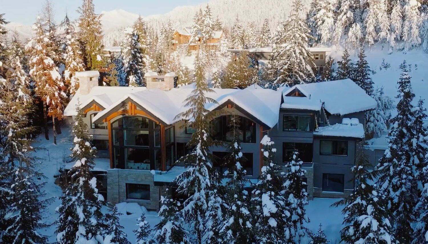 Snow-Covered Whistler Estate Among Old-Growth Evergreens at Sunrise
