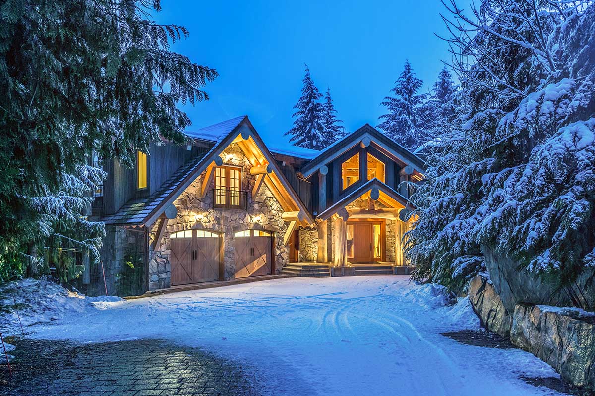 Timber and Stone Mountain Estate Glowing at Dusk in Fresh Whistler Snow